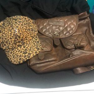Purse backpack and animal print cap.
